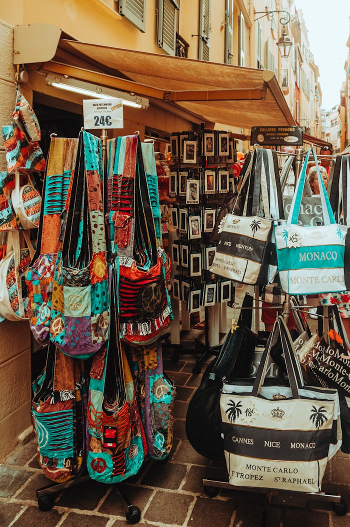 Vibrant display of souvenir bags for sale at a charming street market in Monte Carlo, Monaco.